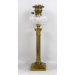 A 19th century oil lamp with cut glass font, raised on a brass stepped column with ionic capital