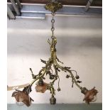 A hanging cast gilt metal ceiling light with four naturalistic twisted branches with entwined floral