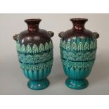 A pair of late 19th century vases in the manner of Dr Christopher Dresser, with relief moulded