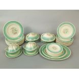 A collection of Susie Cooper dinnerware with green borders and floral detail comprising a pair of