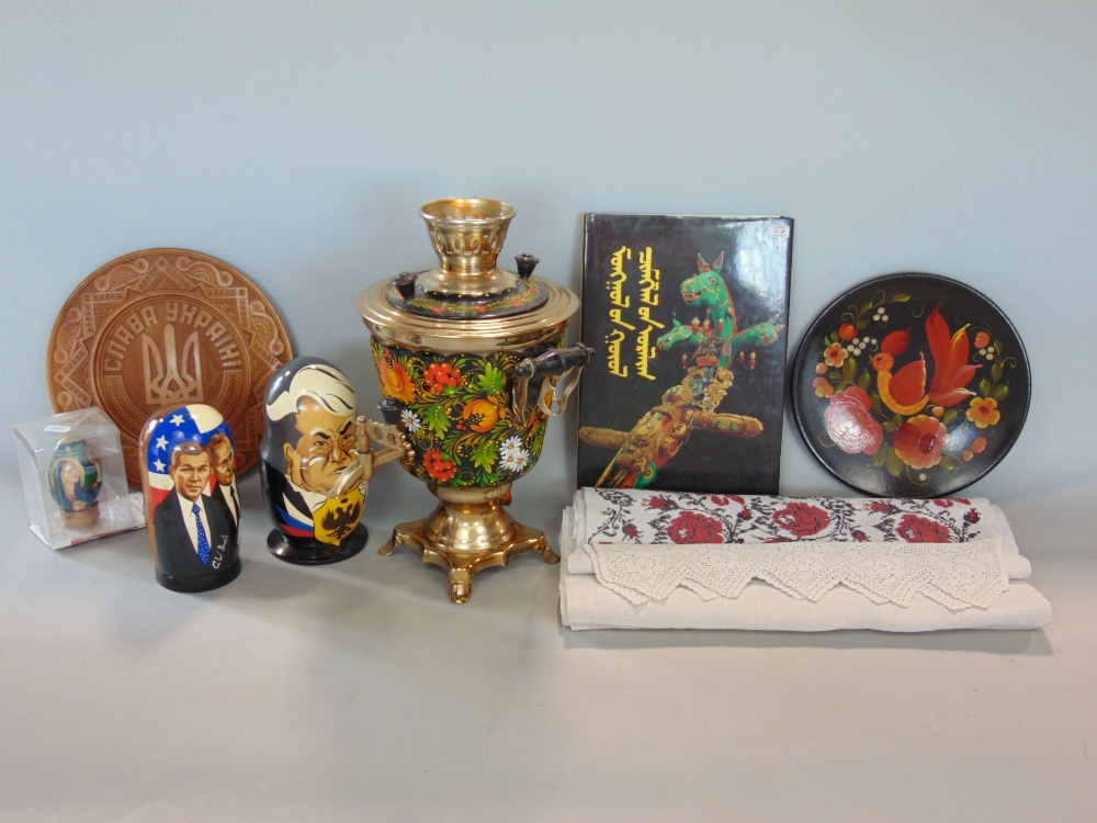 A collection of Russian items to include an ebonised painted samovar, novelty Russian dolls after