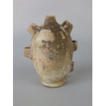 An early terracotta vessel modelled with loop handles, 22cm tall approx