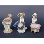 A Lladro Daisa figure of a girl with flower basket, together with two Nao figure groups