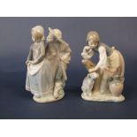 A Lladro figure group of a girl patting a dog, together with a Lladro Daisa group of a boy and a