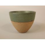 A studio pottery bowl by Robin Welch, of flared form with speckled green glaze finish and