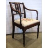 A Regency mahogany elbow chair with reeded frame and hand worked tapestry seat on turned supports