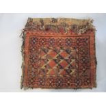 Persian carpet woven saddlebag, 57 x 114 cm together with two sari fabric lengths, one blue, red and