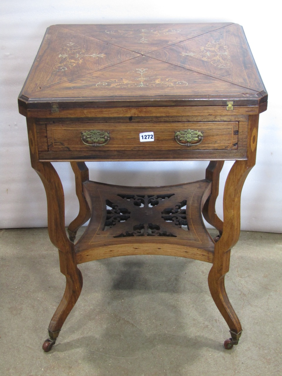 An Edwardian rosewood envelope card table of usual form, with marquetry inlaid detail over a