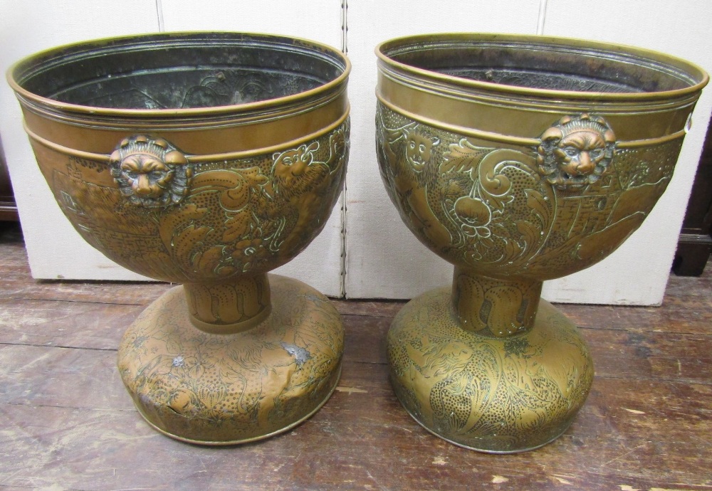 A pair of 19th century hammered brass jardinieres, the repeating detail showing rural life with