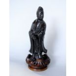 Chinese bronze figure of a standing scholar, 20cm high upon a turned wooden stand