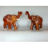 A pair of eastern carved hardwood elephants, the largest 43cm long (2)