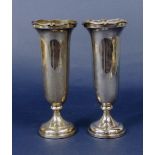 A pair of 1930s tulip type silver vases, with serpentine cast rims, maker RWB, inscribed Harrods,