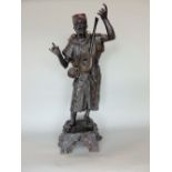 A cast spelter character in the manner of Burgman, of an Arabic musician, 54cm high (af)