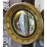 A Regency style gilt framed convex wall mirror with reeded ebonised slip and ball surround, 48 cm