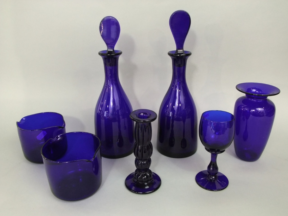 A collection of blue glass to include two Thomas Webb twin spouted finger bowls, a Bristol blue