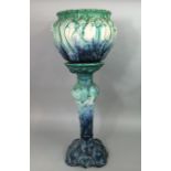 A late 19th century jardiniere and stand with scrolling moulded detail and turquoise and blue glazed