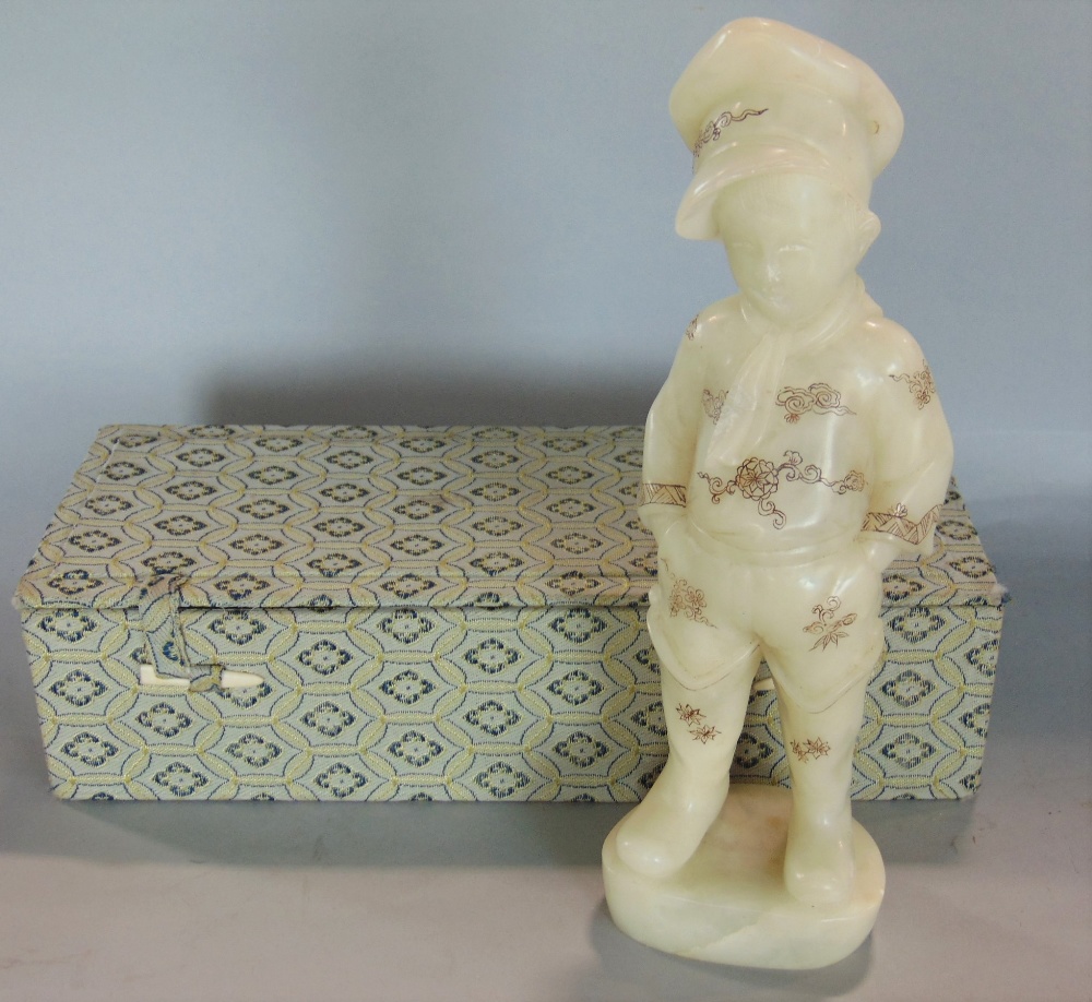 A Chinese cased soapstone study of a standing boy with shibayama type detail, the boy standing