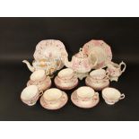 A collection of Victorian pink lustred teawares comprising teapot, milk jug, cake plate, 11 cups and