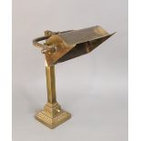 Early 20th century cast brass bankers light upon a square column and stepped circular darted base,