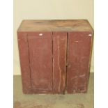 A small rustic painted pine and elm side cupboard enclosed by a tongue and groove panelled door