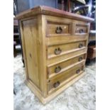 A pinewood chest of three long and two short drawers with ironwork handles, 92 cm wide