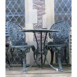 A Victorian style green painted cast aluminium garden terrace table of circular form with decorative