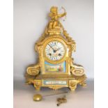 French gilt metal figural mantel clock, mounted by Cupid with Sevres type porcelain panels and dial,