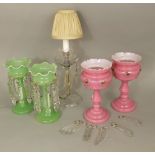 Two pairs of opaline glass lustres, one in pink, the other in green, together with a further