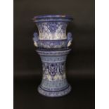 A continental tin glazed earthenware jardiniere and stand in the Delft manner with blue and white