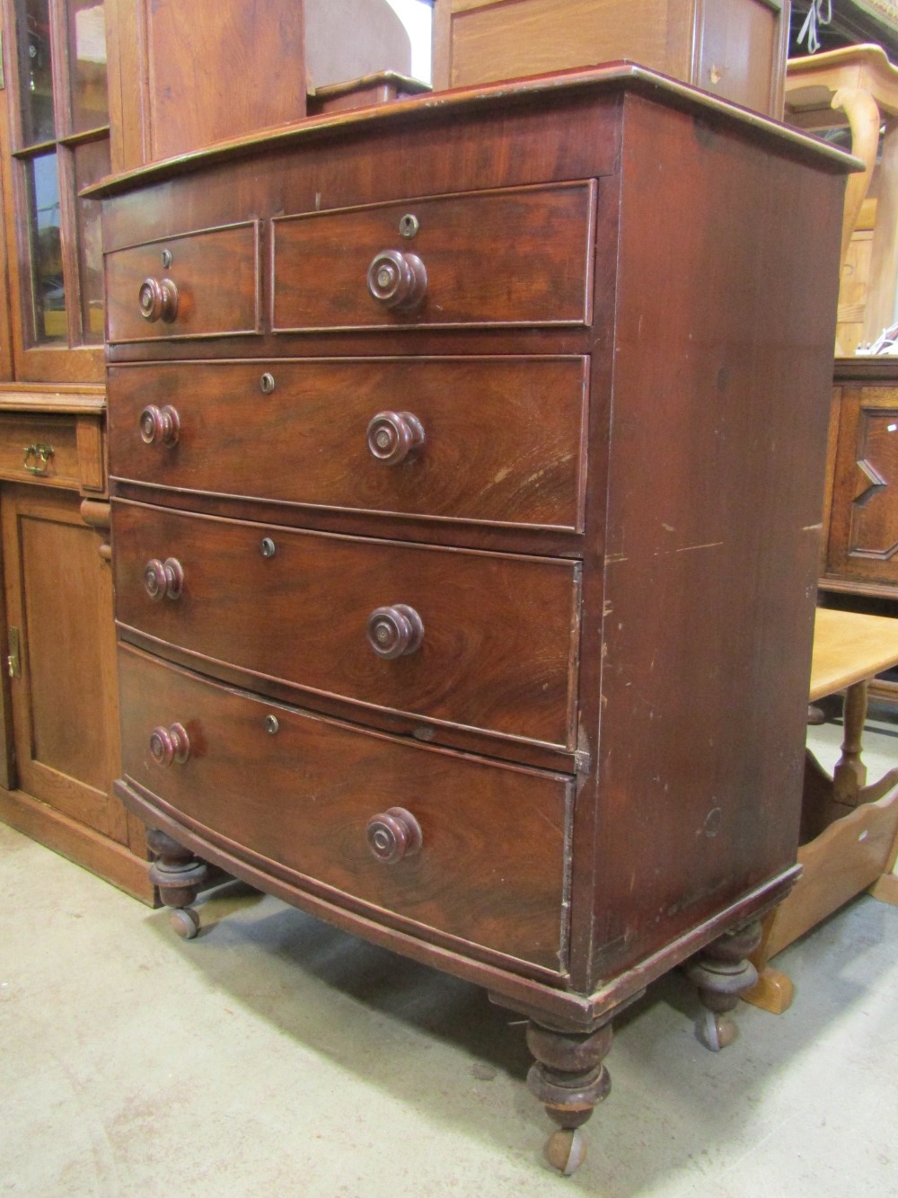 A Victorian mahogany bow fronted chest of three long and two short drawers on turned supports, 95 cm