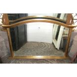 A 19th century style arched and gilded overmantel mirror, the moulded frame with acanthus detail,