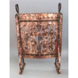 A good quality Arts & Crafts riveted and pierced copper firescreen with wrought iron strap work,