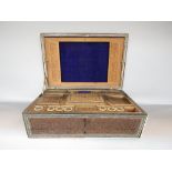 A 19th century sandalwood and inlaid sarcophagus shaped ladies work box with comprehensively