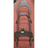 An antique hardwood steel and brass overlaid camel saddle (possibly North African)