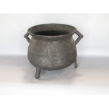 Antique bronze ovoid cauldron, with twin triangle handles and three feet, 22cm high