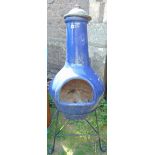A contemporary blue glazed chiminea and steel stand