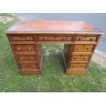 A Victorian satin walnut pedestal desk and banded with nine drawers