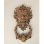 Good quality cast bronze door knocker, the back in the form of a mythical beast mask, the knocker