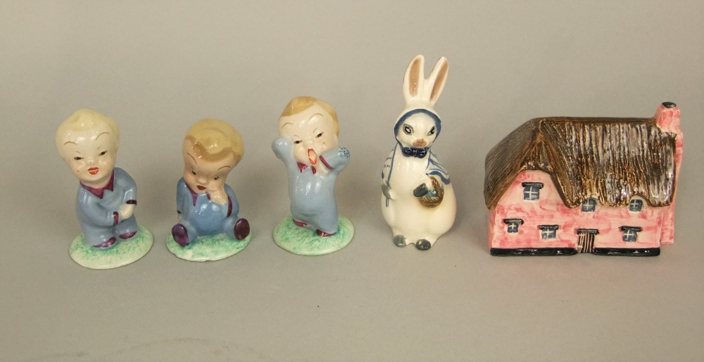 A set of three Wade nursery figures of Wynken, Blynken and Nod, a ceramic figure of a rabbit in blue