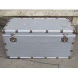 A substantial aluminium clad travel trunk with strengthened bands