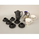 A Keith Murray black basalt coffee pot, six Wedgwood black basalt coffee cans and saucers,