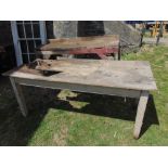 A 19th century pine farmhouse kitchen table of rectangular form with boarded top raised on four