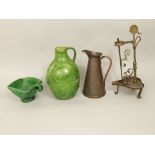 An unusual green glazed pottery jug with moulded and incised triple sun burst detail, 25.5cm tall, a