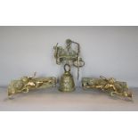 A pair of polished cast brass wall sconces in the form of cherubs, with poker work and foliate