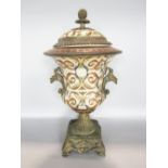 Eastern porcelain and cast metal lidded urn, the lid with fruiting finial and darted borders over