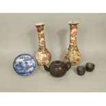 A pair of late 19th century Satsuma vases of bottle shaped form with figure detail, 31cm tall,