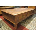 A substantial eastern hardwood low centre table of rectangular form fitted with six drawers with