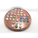 Antique mahogany solitaire board, complete with further antique marbles with various mottled and