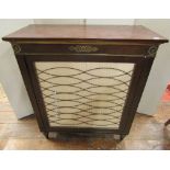 A small Regency style side cupboard, the single door with pleated panel detail and brass grill