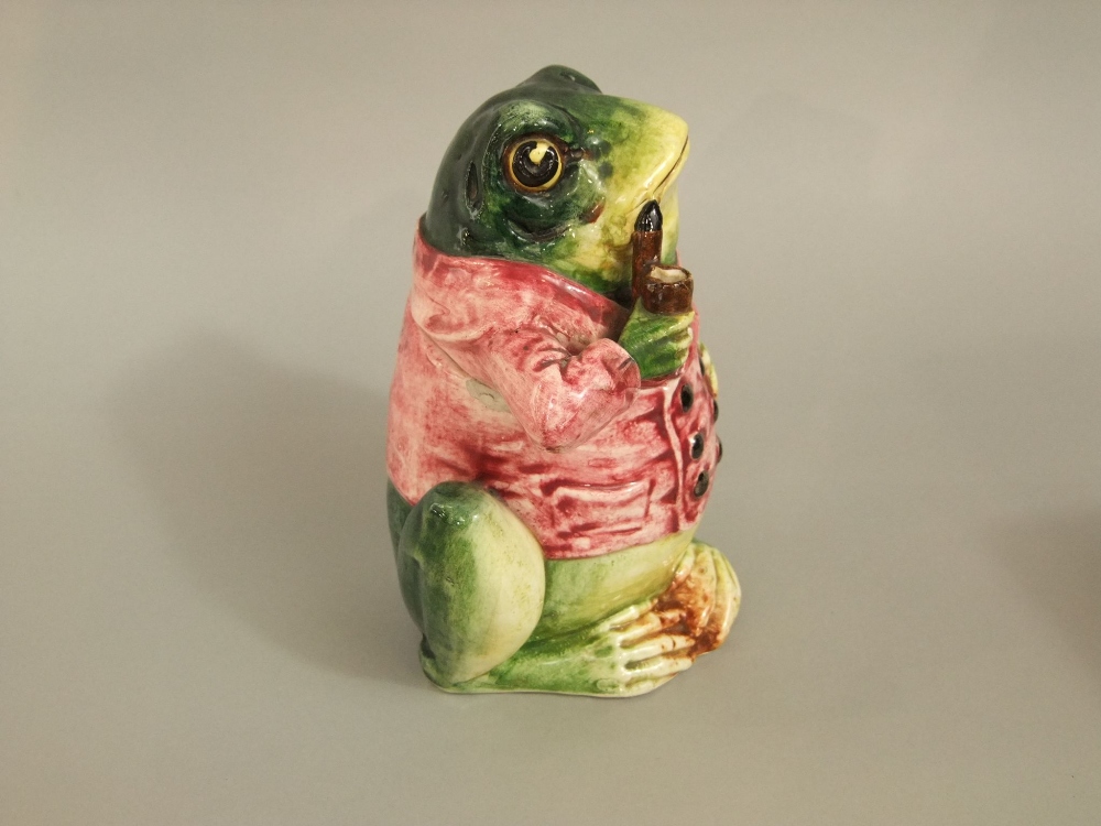 A late 19th century continental tobacco jar and cover in the form of a pipe smoking frog in a pink - Image 3 of 5